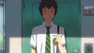 boy in tie holding phone by green door — Your Name