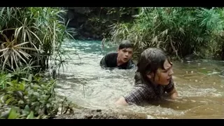 two men crawling in front of waterfall — Jurassic World