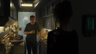 man holding coffee cup in dimly lit kitchen — Blade Runner 2049