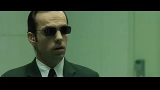 man in suit and sunglasses holding temple — The Matrix