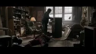 man in cluttered room with person in red suit — Deadpool