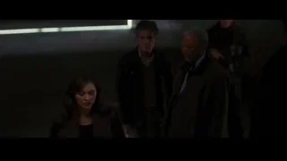 People gathered in a dimly lit room — Batman: The Dark Knight Rises