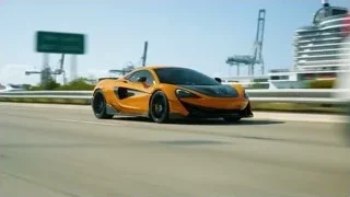 orange McLaren P1 driving past cruise ship — Sports Cars