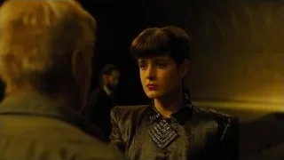 woman and man looking at each other in dim room — Blade Runner 2049