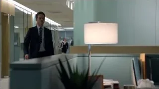 Man in suit speaking in office lobby — Suits