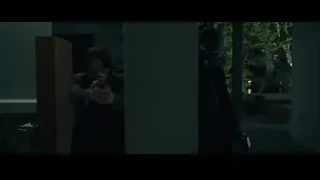man holding gun in dark room — John Wick