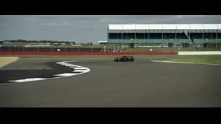 Black race car on track with stadium — F1
