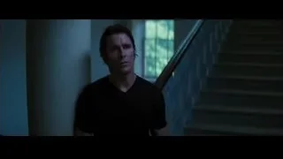 man contemplating in dimly lit room with staircase — Batman: The Dark Knight Rises