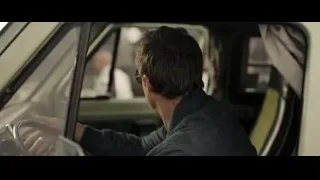 Man sitting in car in garage — F1