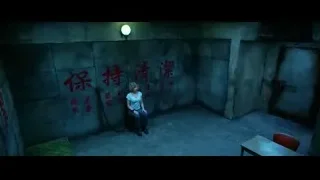 woman in dimly lit room with Chinese characters — Lucy