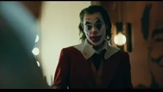 Joker standing in dimly lit room — Joker