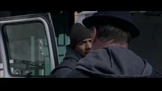 two men talking in front of white van — Creed