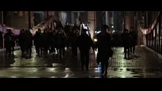 people walking on wet street at night — Batman