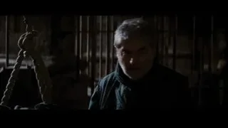 Man in dimly lit room deep in thought — Batman: The Dark Knight Rises