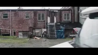 man sitting in a car — Deadpool