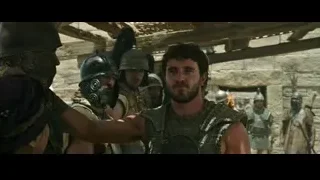 Men in Roman armor conversing by stone wall — Gladiator 2