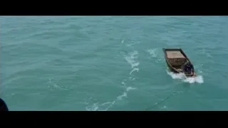 person fishing from small wooden boat in ocean — Bruce Lee: Enter The Dragon