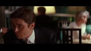 Man in suit sitting at restaurant table — Batman