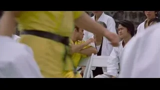 Men in robes sitting in room with stone wall — Bruce Lee: Enter The Dragon
