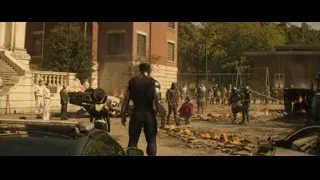Man in suit and helmet by large fire — Deadpool 2