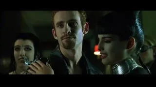 Man with beard embracing woman in dim light — The Matrix