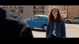 young woman standing in parking lot with blue Beetle — Steve Jobs
