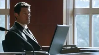 Man in suit sitting at office desk with laptop — Suits