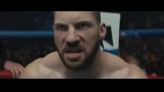Shirtless man in boxing ring with crowd — Creed 2
