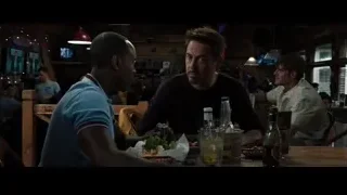 men sitting at wooden table in restaurant — Iron Man 3