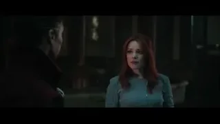 Man and red-haired woman smiling in dimly lit room — Doctor Strange 2