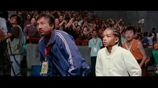 man and young girl in front of crowd — The Karate Kid