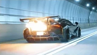 black sports car driving through tunnel — Sports Cars