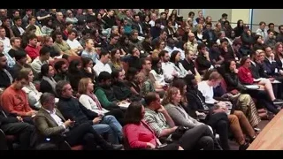 people in lecture hall watching presentation — The Social Dilemma