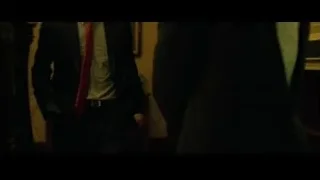 two men in suits one smoking — The Social Network