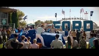 crowd gathered at Mustang Ford sign — Ford v Ferrari