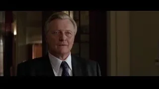 middle-aged man in suit in hallway — Batman