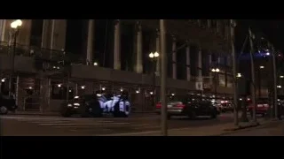 Futuristic black car driving on city street — Batman