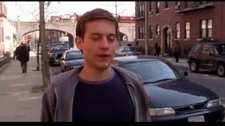 young man on busy street with serious expression — Spider Man