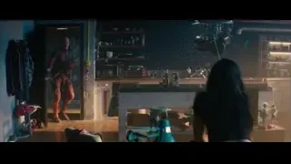 man holding gun in tiled kitchen — Deadpool 2