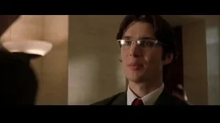 man in suit and glasses with serious expression — Batman
