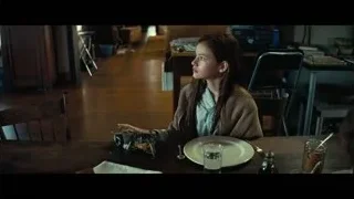 young girl sitting at table — Interstellar