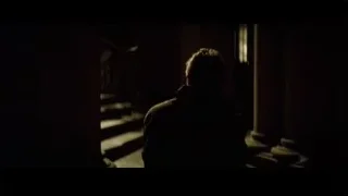 Man holding gun on dark staircase — Batman