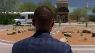 Man in suit by building with American flag — Breaking Bad