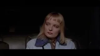 woman sitting in dark room — American Psycho