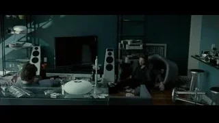 Cluttered living room with two people on couch — Limitless