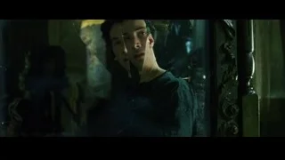 young man standing in dimly lit room — The Matrix