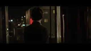 man in suit looking out at city night — Batman