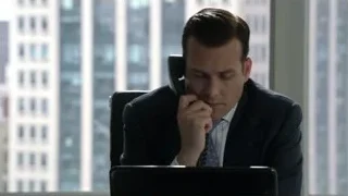 man in suit on phone at desk — Suits