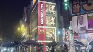 McDonald's on busy city street at night — Weathering with You