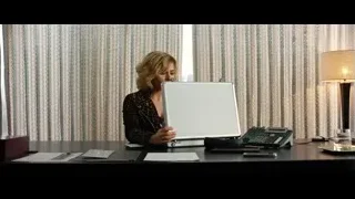 woman holding whiteboard at office desk — Lucy